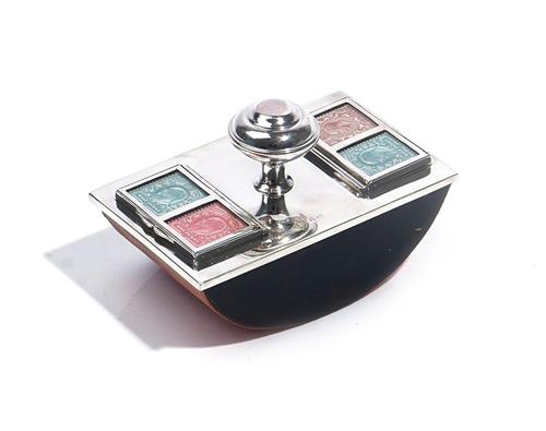 A SILVER MOUNTED POSTAGE STAMP HOLDER / DESK BLOTTER