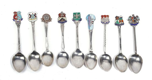 A GROUP OF NINE SILVER AND ENAMELLED SOUVENIR SPOONS (9)