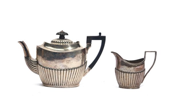 A  LATE VICTORIAN SILVER TEAPOT AND A MATCHING MILK JUG (2)