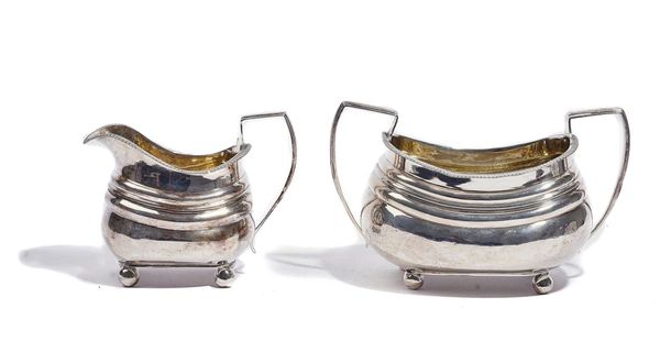 A GEORGE III SILVER SUGAR BOWL AND A MATCHING MILK JUG