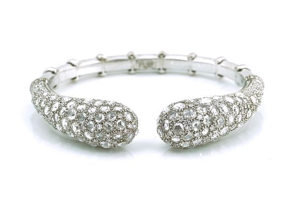 A DIAMOND SET HINGED BANGLE OF TORC DESIGN BY VIRGINIA CAPRI