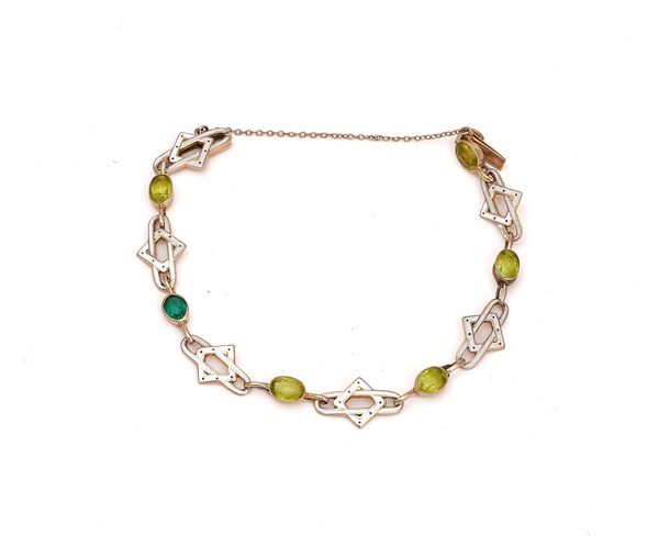 A GOLD, ENAMELLED, PERIDOT AND GREEN GEM SET BRACELET