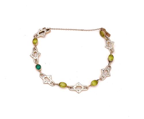 A GOLD, ENAMELLED, PERIDOT AND GREEN GEM SET BRACELET