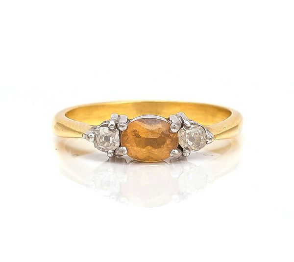 A GOLD, TOPAZ AND DIAMOND THREE STONE RING