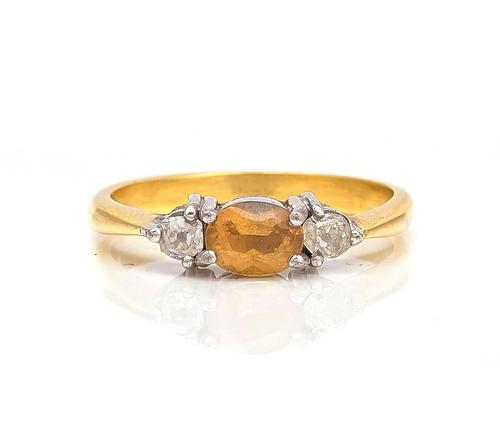 A GOLD, TOPAZ AND DIAMOND THREE STONE RING