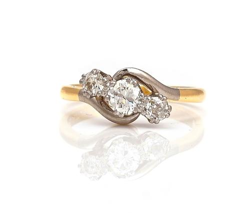 A GOLD AND DIAMOND THREE STONE RING