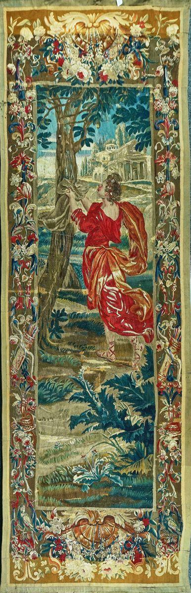 A FLEMISH VERDURE TAPESTRY DEPICTING A RED ROBED FIGURE BENEATH A TREE