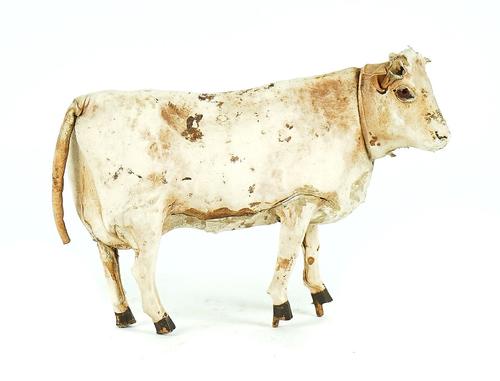 A LEATHER COVERED TOY COW