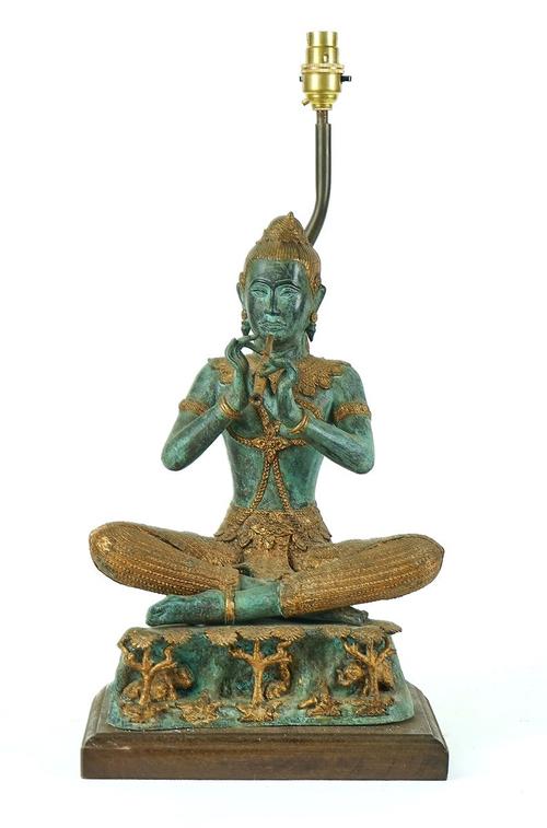 A PATINATED & GILT BRONZE MODEL OF A THAI MUSICIAN