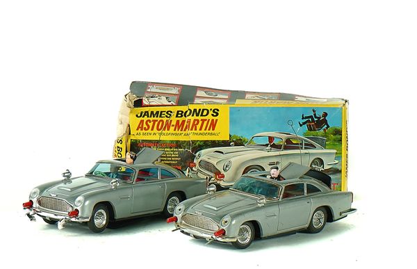 TWO GILBERT JAMES BOND TINPLATED ASTON MARTIN DB5'S (2)