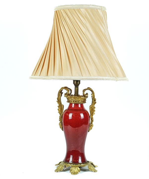 A FRENCH GILT-METAL MOUNTED SANG DE BOEUF GLAZED TABLE LAMP