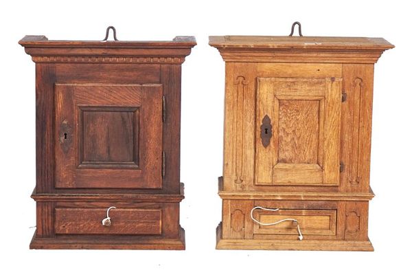 A NEAR PAIR OF CONTINENTAL OAK HANGING CUPBOARDS (2)