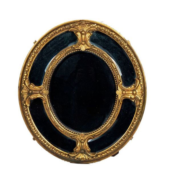 A VICTORIAN GILT-PLASTER OVAL MARGINAL WALL MIRROR