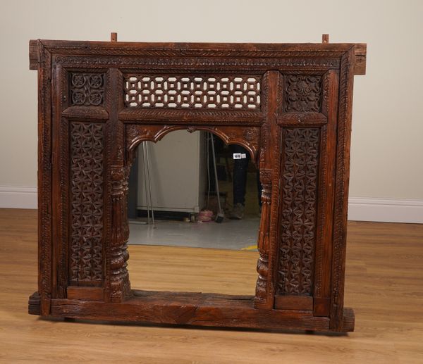 A 19TH CENTURY INDIAN CARVED HARDWOOD WINDOW WITH LATER MIRROR PLATE