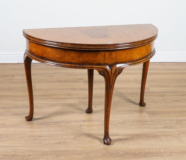 A GEORGE I STYLE FIGURED WALNUT DEMI-LUNE TEA TABLE