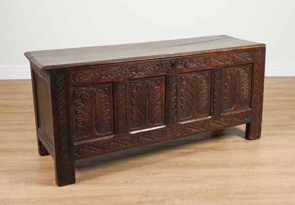 A 17TH CENTURY AND LATER OAK COFFER WITH CARVED FOUR PANEL FRONT