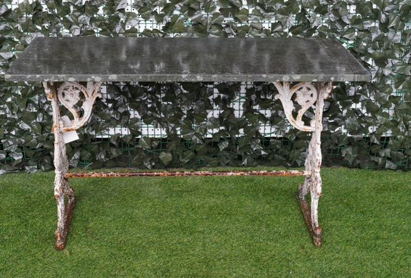 A RECTANGULAR STONE TOP GARDEN TABLE ON WHITE PAINTED 19TH CENTURY CAST IRON BASE