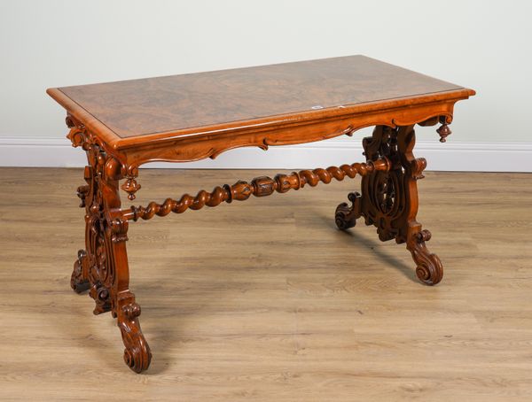 A VICTORIAN FIGURED WALNUT RECTANGULAR CENTRE TABLE ON PIERCED TRESTLE SUPPORTS