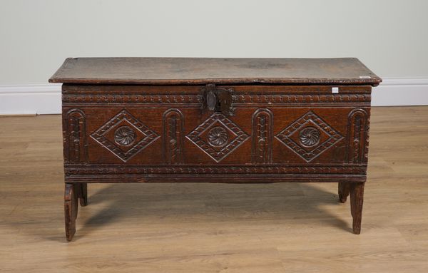 A 17TH CENTURY AND LATER OAK PLANK COFFER WITH CARVED FRONT