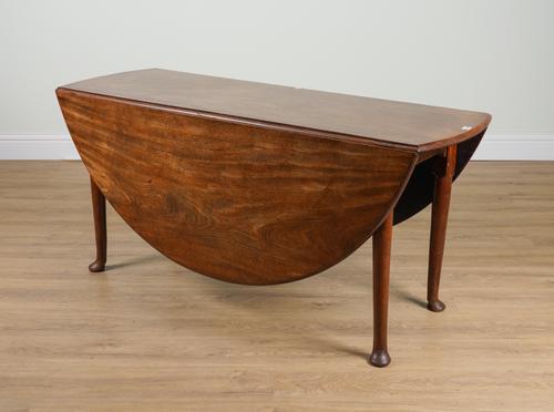 A GEORGE II MAHOGANY OVAL DROP-FLAP DINING TABLE