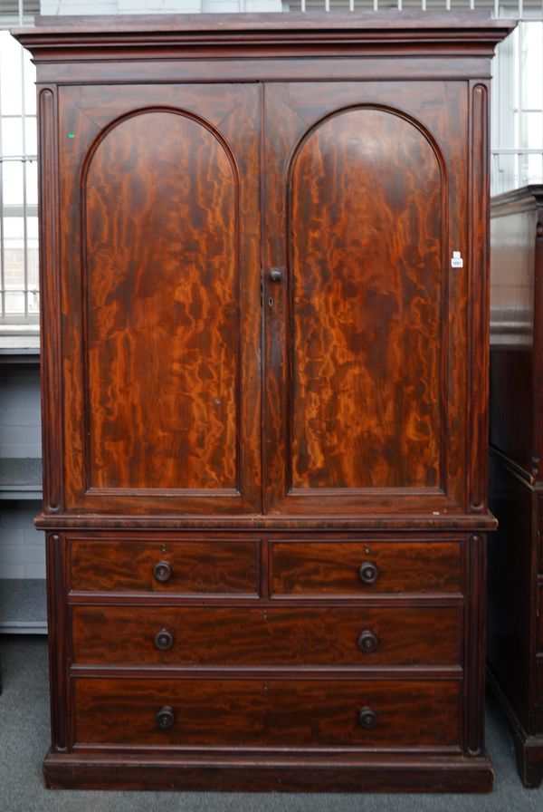 A VICTORIAN MAHOGANY LINEN PRESS WITH FITTED INTERIOR OVER FOUR DRAWERS