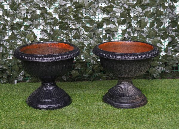 A NEAR PAIR OF BLACK PAINTED CAST-IRON CIRCULAR JARDINIERES OF HOUR-GLASS FORM  (2)