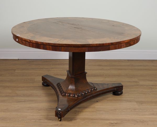 A VICTORIAN CIRCULAR SNAP-TOP LIBRARY CENTRE TABLE ON TREFOIL BASE