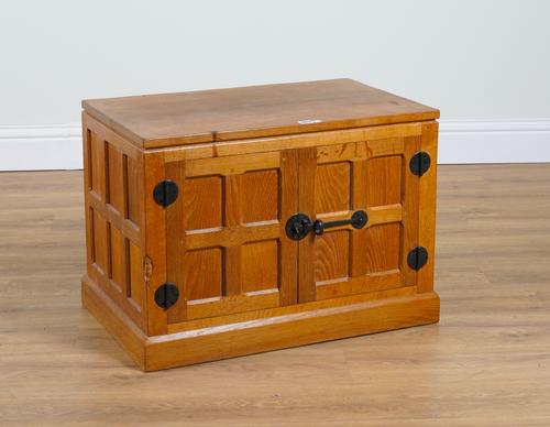ROBERT MOUSEMAN THOMPSON OF KILBURN; AN ADZE OAK TWO DOOR SIDE CABINET ON PLINTH BASE