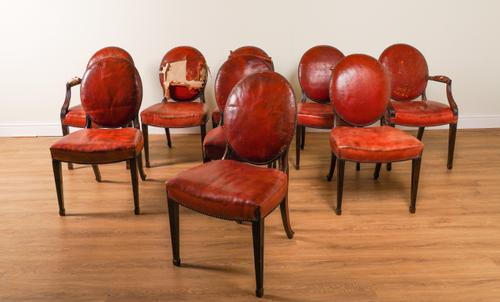 A SET OF NINE GEORGE III STYLE STUDDED ROUGE LEATHER UPHOLSTERED MAHOGANY FRAMED DINING CHAIRS (9)