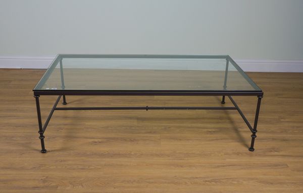 A MODERN BLACK IRON FRAMED GLASS MOUNTED COFFEE TABLE