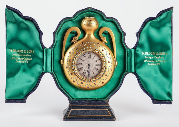 AN UNUSUAL VICTORIAN GILT-BRASS TURQUOISE AND PASTE SET STRUT TIMEPIECE IN THE FORM OF A TWIN-HANDLED URN