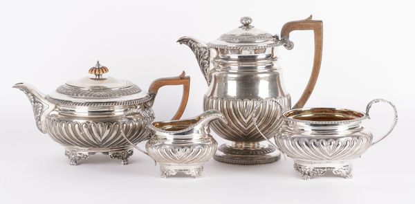 A SILVER THREE PIECE MATCHED TEA SET AND A SILVER HOT WATER JUG (4)