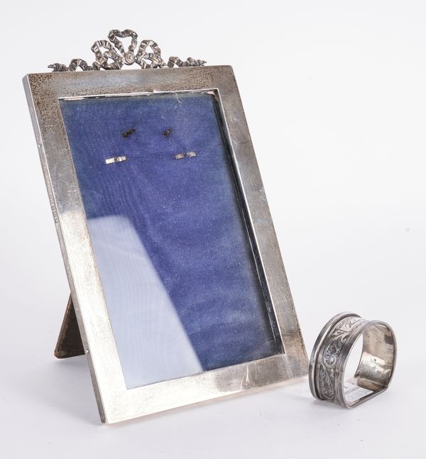 A SILVER MOUNTED PHOTOGRAPH FRAME AND A NAPKIN RING (2)