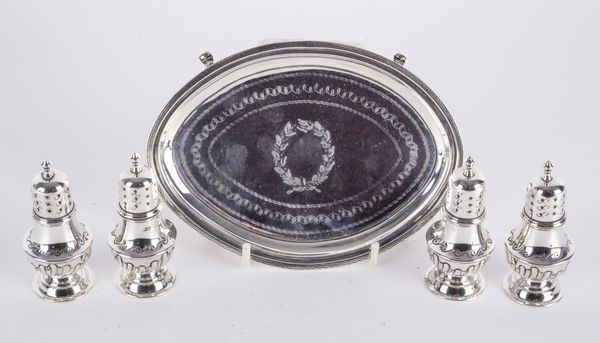 A GEORGE III SILVER TEAPOT STAND AND FOUR SILVER PEPPERETTES (5)