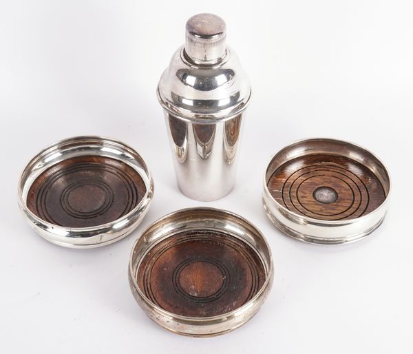 THREE SILVER MOUNTED BOTTLE COASTERS AND A PLATED COCKTAIL SHAKER (4)