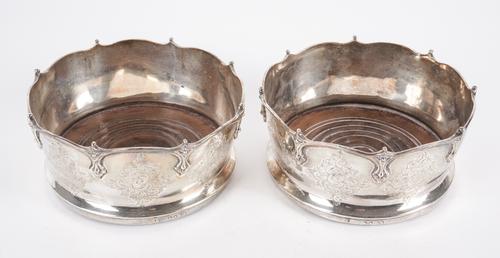 A PAIR OF EARLY VICTORIAN SILVER MOUNTED BOTTLE COASTERS (2)