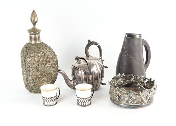 A SILVER MOUNTED DOULTON JUG, TWO SILVER CUP STANDS AND THREE PLATED ITEMS (6)