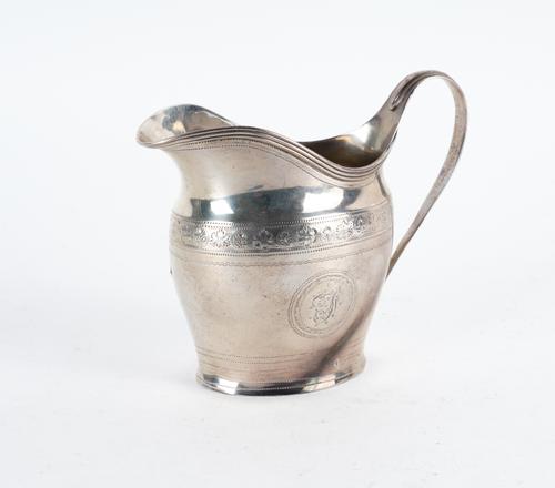 A GEORGE III SILVER CREAM JUG