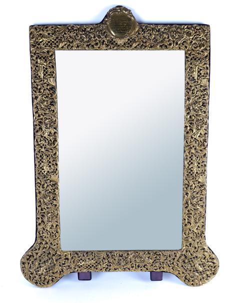 A LATE VICTORIAN SILVER GILT MOUNTED SHAPED RECTANGULAR STRUT BACKED MIRROR