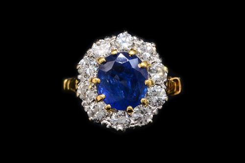 A SAPPHIRE AND DIAMOND OVAL CLUSTER RING
