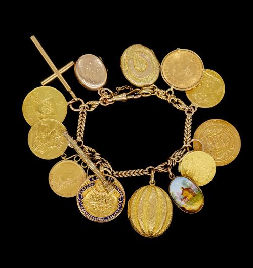 A CHARM BRACELET WITH SOVEREIGNS, PENDANTS AND MEDALLIONS