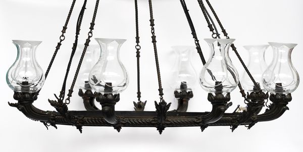 A REGENCY STYLE PATINATED METAL EIGHT LIGHT CHANDELIER