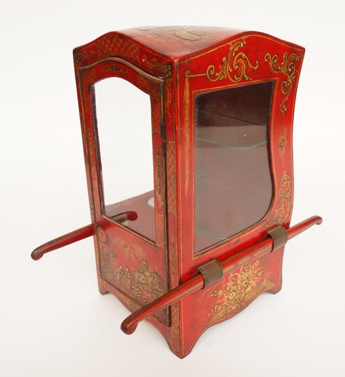 A GILT-DECORATED CHINOISERIE RED JAPANNED MINIATURE SEDAN VITRINE