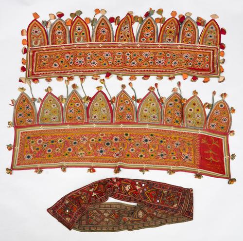 FOUR INDIAN GUJURAT EMBROIDERED TORAN, TOGETHER WITH WALL HANGINGS AND FRAGMENTS (10)