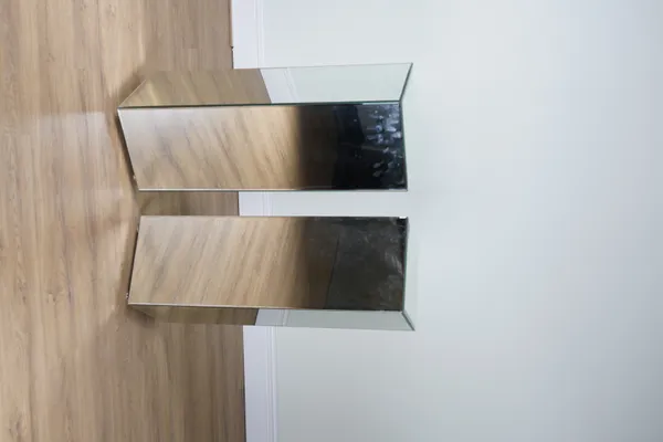 A PAIR OF MIRRORED GLASS SQUARE PEDESTALS (2)