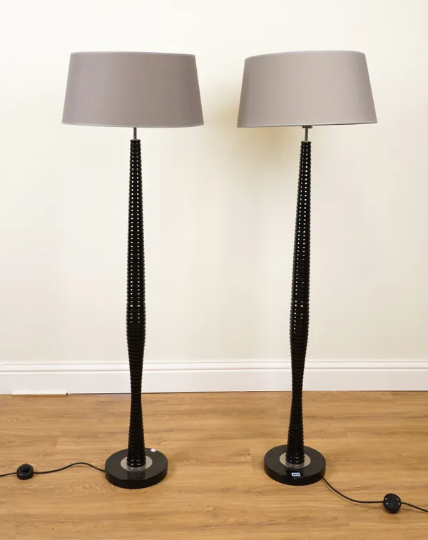 A PAIR OF BLACK PAINTED RIBBED STANDARD LAMPS (2)