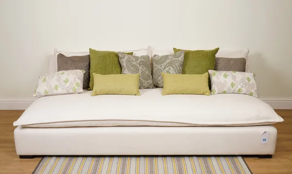 CUSHIONS, A GROUP OF TEN CUSHIONS IN GREENS (10)