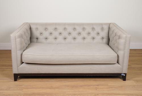 REVAMPINTERIORS.CO.UK, A GREY UPHOLSTERED BUTTON BACK SOFA ON EBONISED SUPPORTS