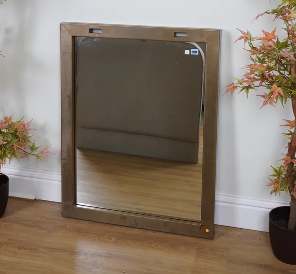 A GOLD PAINTED METAL WALL MIRROR WITH HANGING SUPPORTS