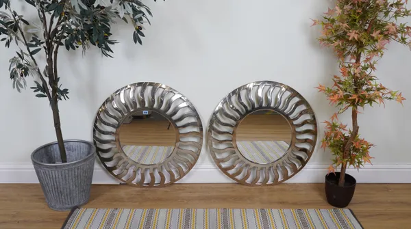 A PAIR OF SILVERED METAL CIRCULAR WALL MIRRORS (2)